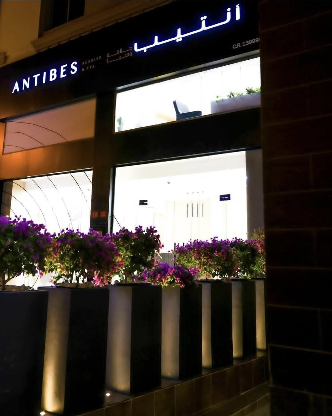 Antibes storefront signage at night